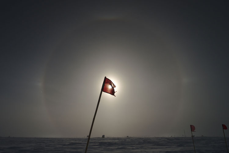 Sundogs with battered flag at center covering sun