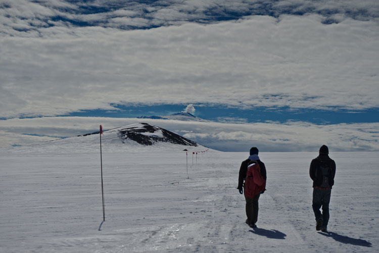 Two hikers walking toward Castle Rock.