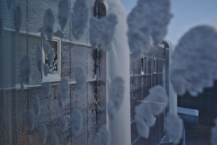 View thru window with blotches of icy snow stuck to window.