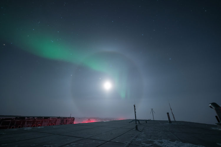 Halo around moon, with auroras