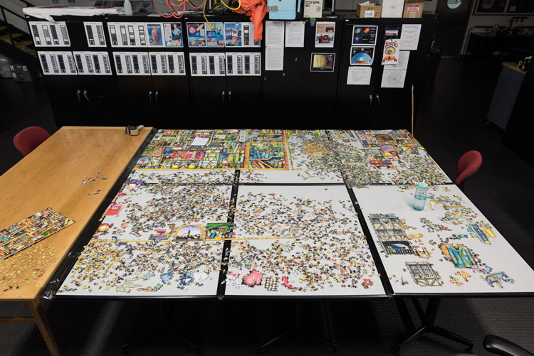 jigsaw puzzle in progress, spread across several tabletops