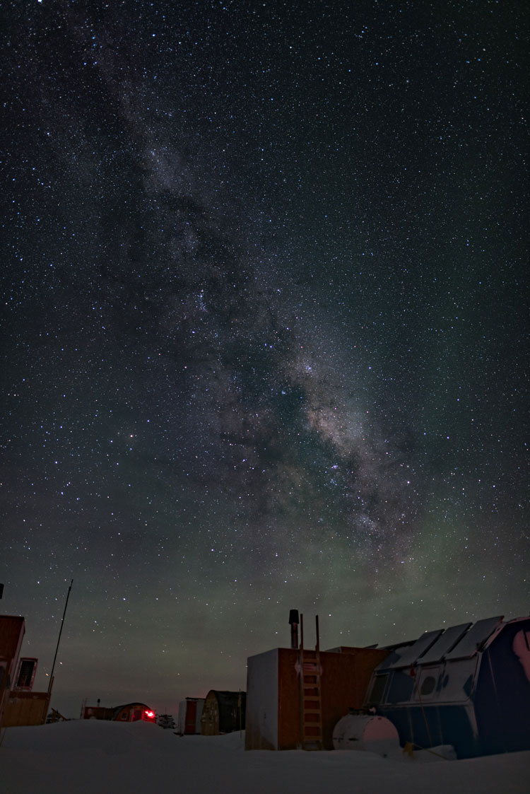 Vertical photo with starry sky, light auroras, and Milky Way
