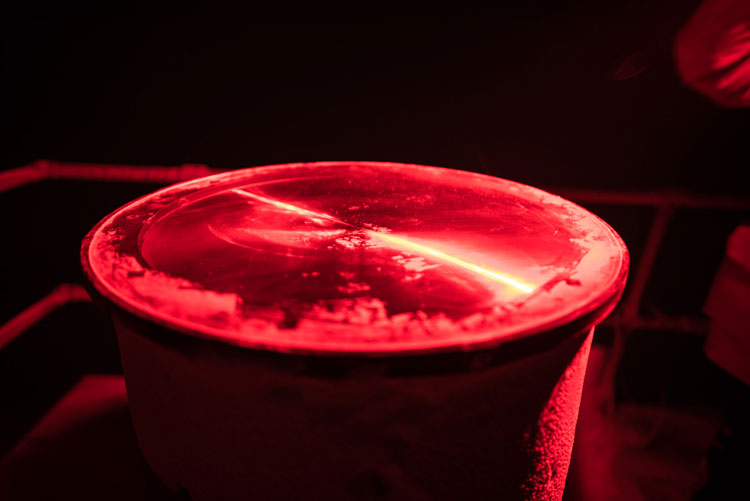 Close-up of frosted glass telescope lens under red light
