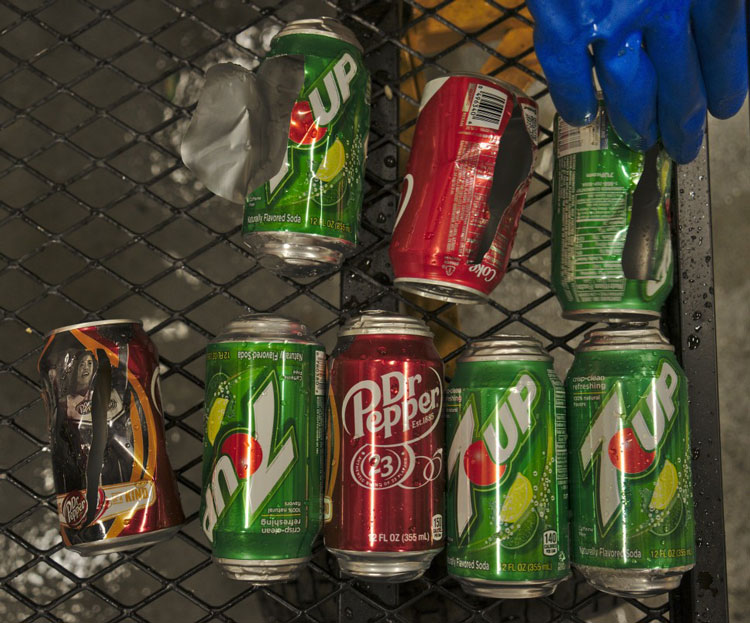 Close-up of soda cans, some exploded