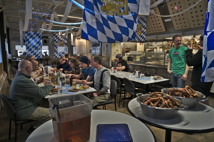 People seated at long table in galley decorated for Oktoberfes