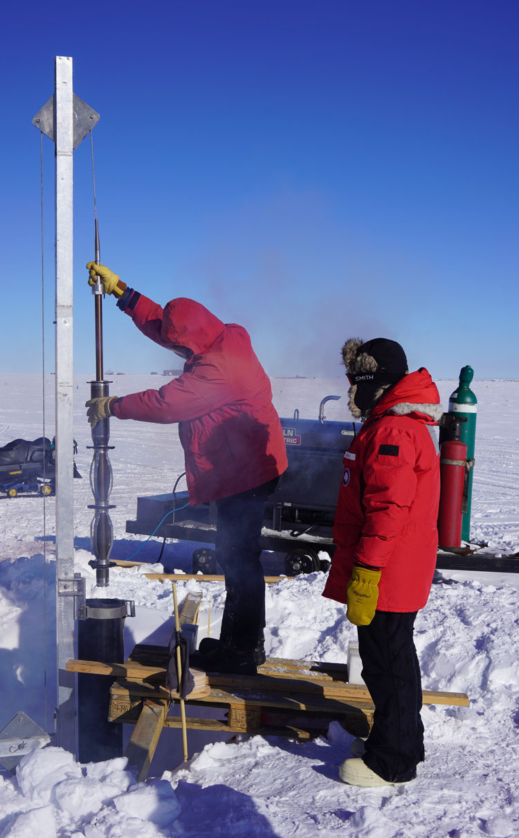 People installing equipment outdoors at South Pole