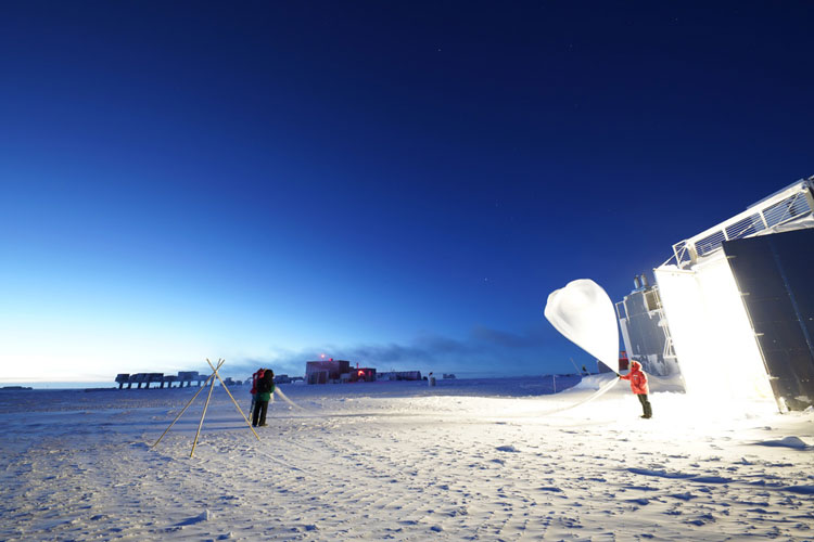 Distant view of weather balloon launch at twilight at South Pole