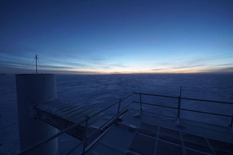 Bluish sky and landscape with light on horizon at twilight at South Pole