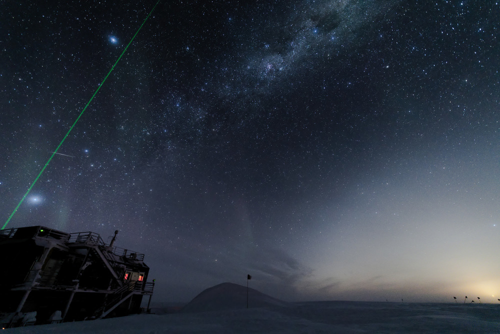 LIDAR beam directed up into starry sky at south pole