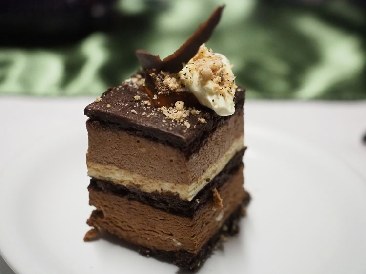 Close-up of slice of layered mousse cake