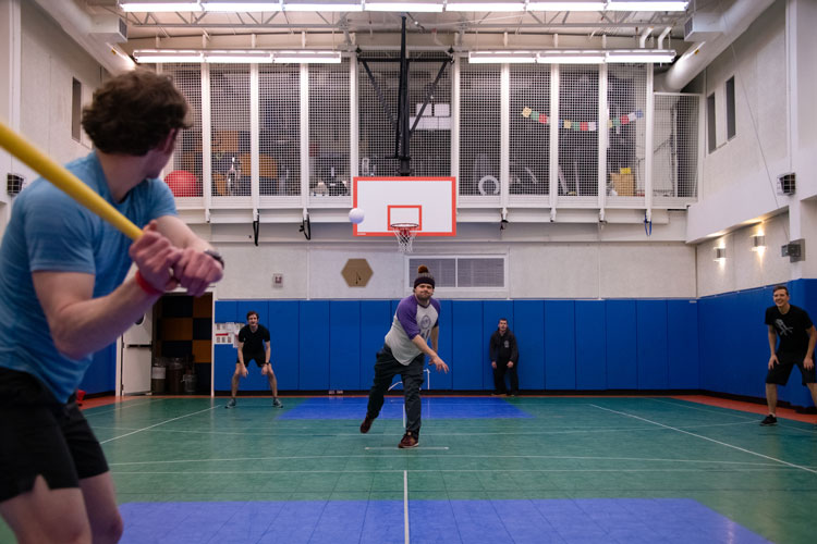 Playing indoor wiffle ball, catcher's view