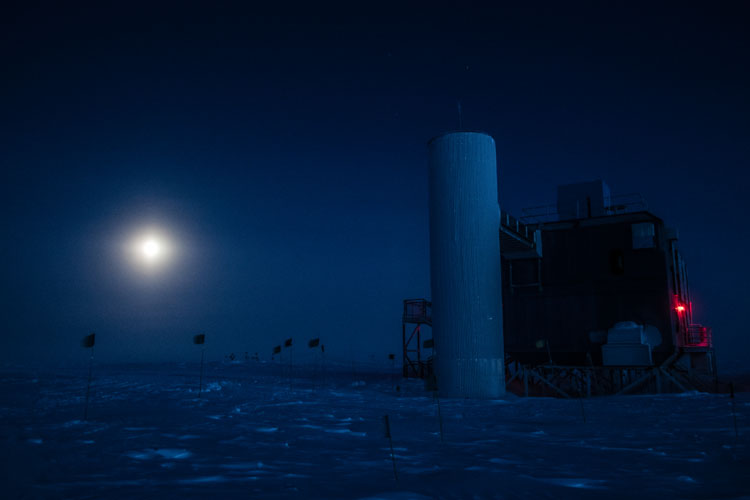 Distant low moon, near IceCube Lab, dark photo.