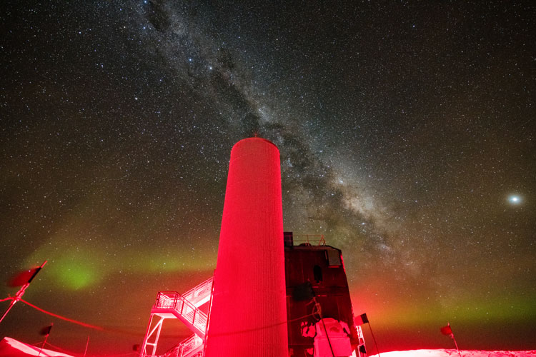 IceCube Lab lit up in red with starry sky