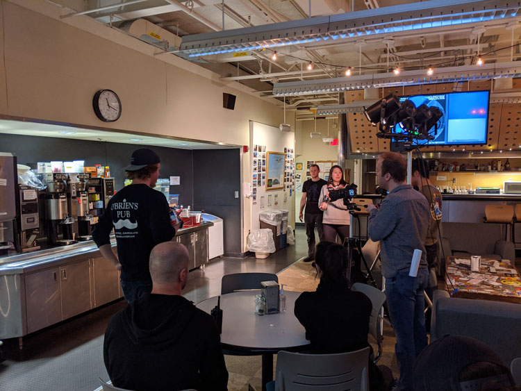 Group filming in the galley of the station