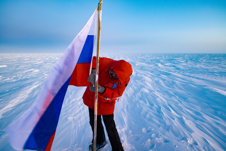 Person adjusting flag on a pole