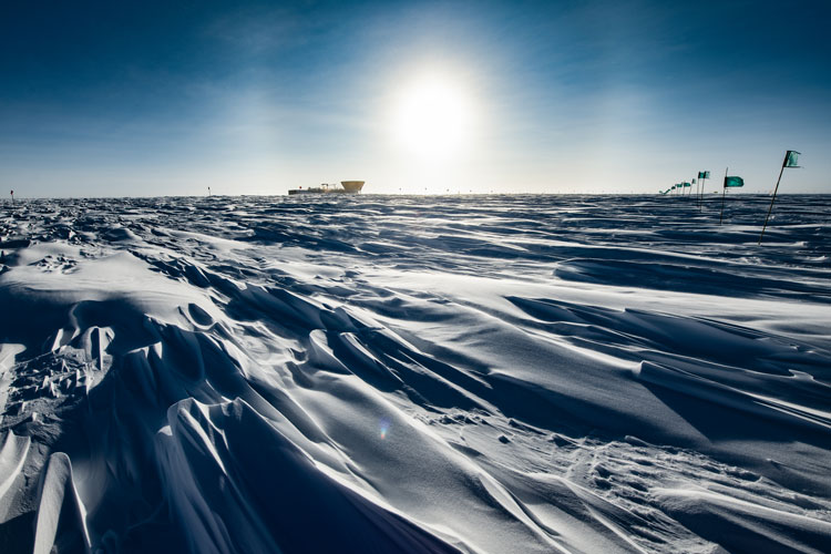 Shadowy ridges of sastrugi covering snow surface