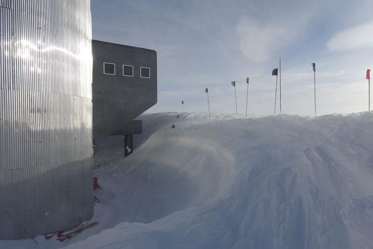 Huge snow drift around tower side of South Pole station.