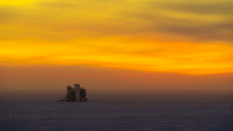 The IceCube Lab at sunset, with orange cloud-filled sky.