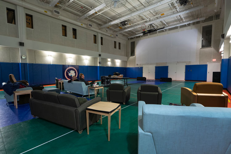 Gymnasium set up with sofas and armchairs.