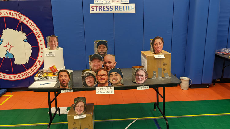 Photos of people’s faces attached to cans for a carnival game.