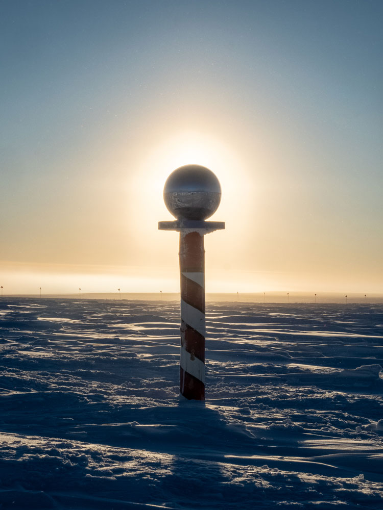 Ceremonial pole marker backlit by the rising sun.
