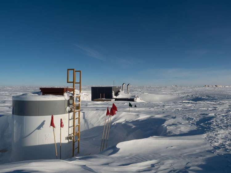 Two structures on the surface at the South Pole—an ice tunnel escape hatch and the rodwell building.