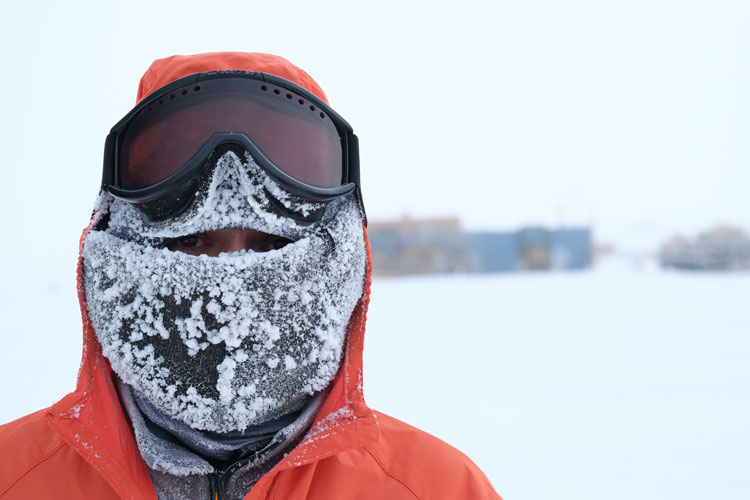 Winterover outside after South Pole marathon, up close with face completely covered in frosted balaclava.