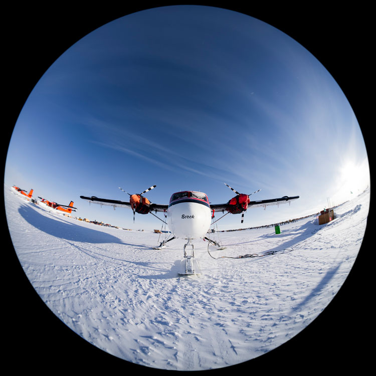 Fish-eye view of front of a small aircraft parked at South Pole.