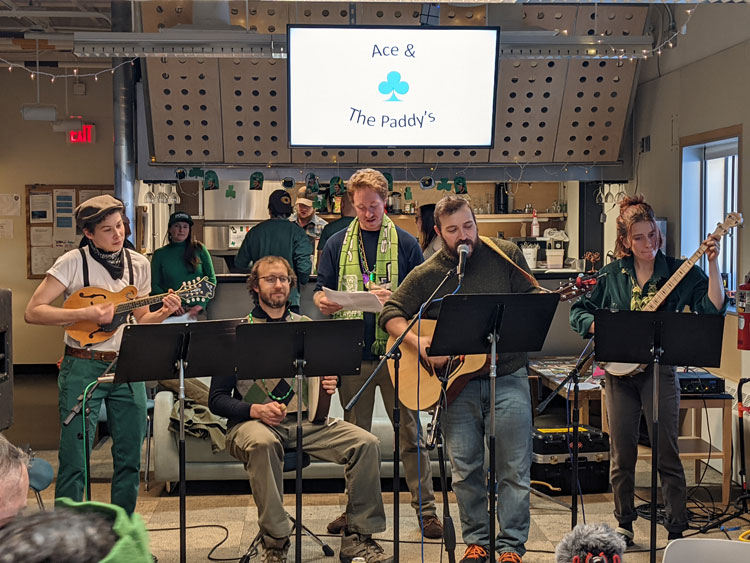 Group of musicians, with various instruments and in front of music stands, performing at the South Pole station.