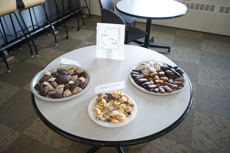 Three large trays of cookies set out on a table