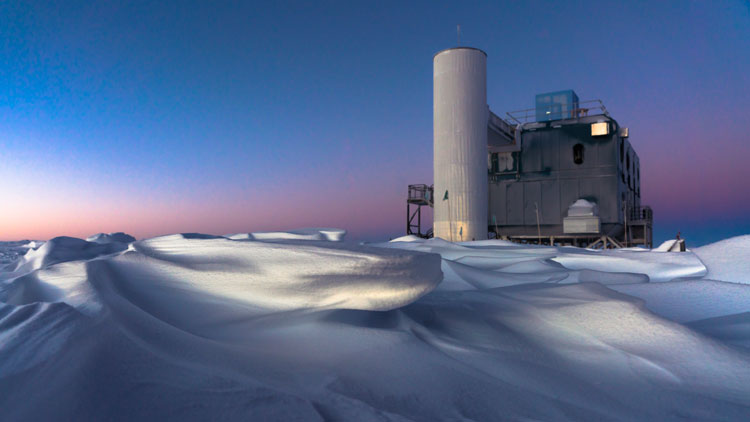 IceCube Lab at twilight, snow drifts in foreground