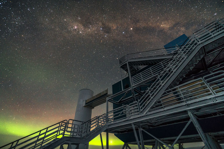 IceCube Lab's stairs with low aurora and Milky Way overhead