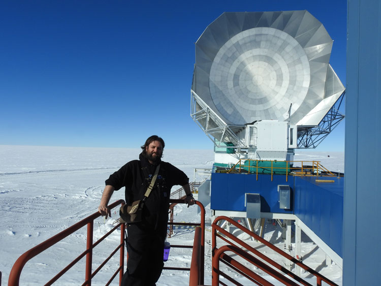 IceCube winterover James outside the South Pole Telescope