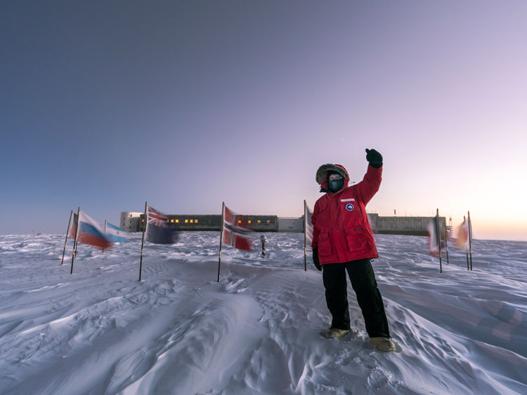 Person standing for selfie at the ceremonial South Pole.
