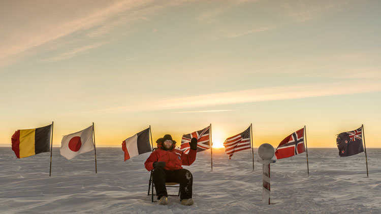 Martin sitting in chair at ceremonial Pole during sunrise