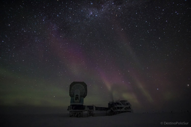 The South Pole telescope with auroras in the background. 