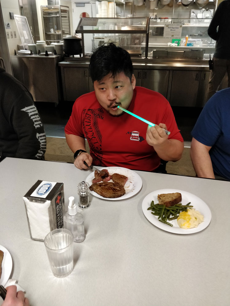 Person eating with lighted chopsticks