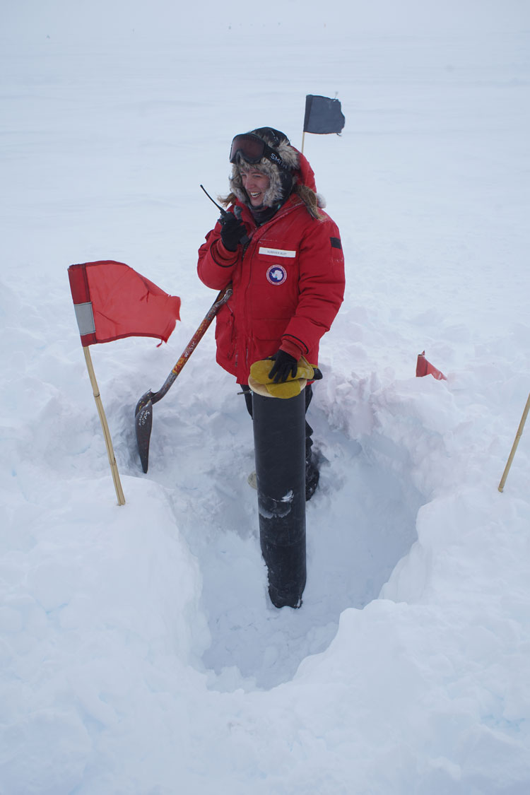 Person standing around a dug out area in the snow