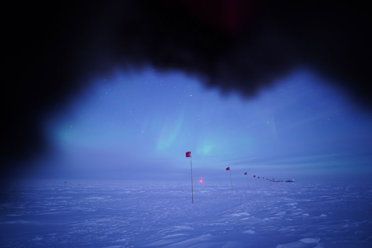Flag line at twilight with subtle auroras, view partially blocked from photographers hood