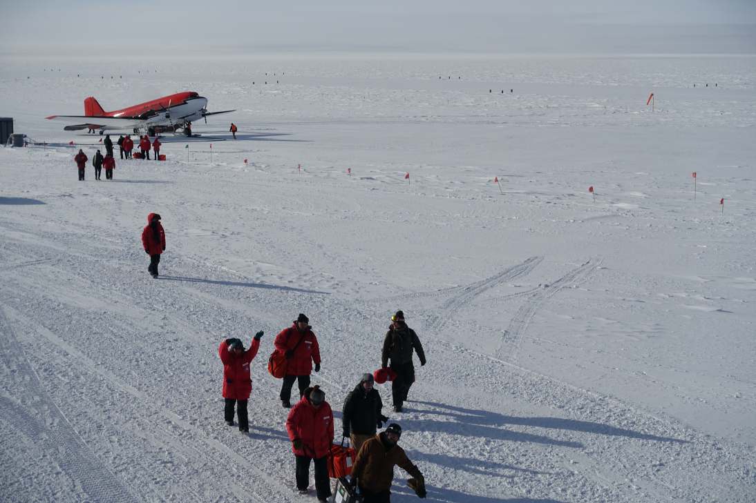 New arrivals walking from plane to station