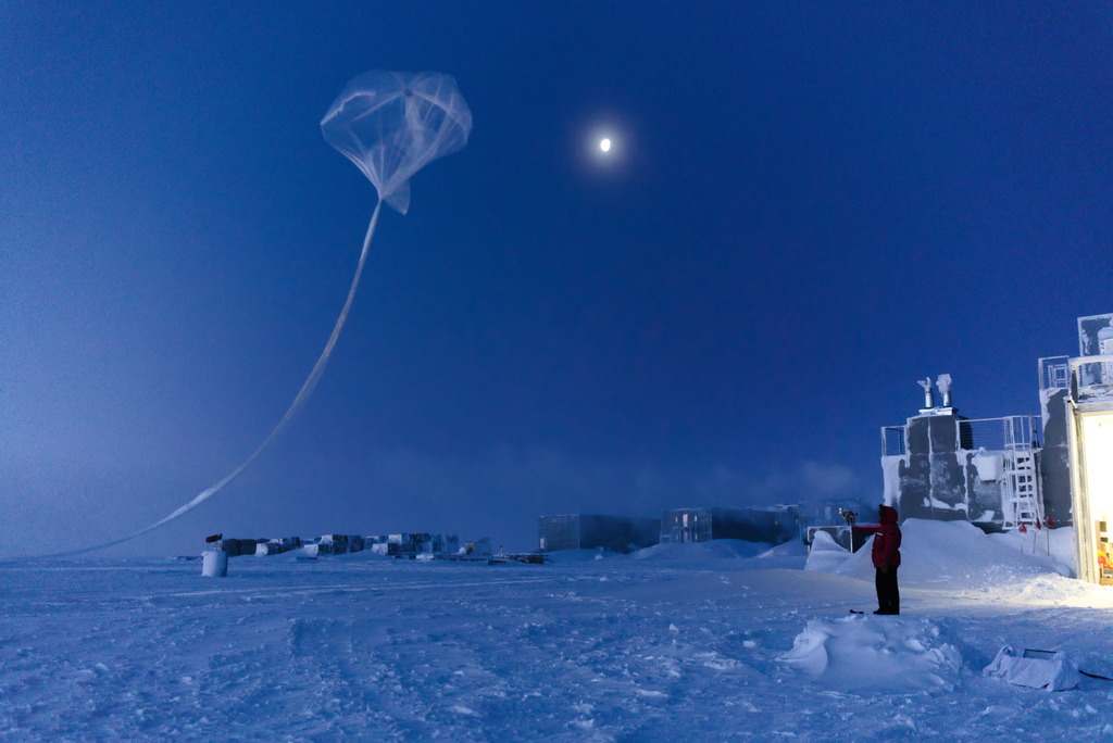 Person standing as weather balloon launches at the South Pole