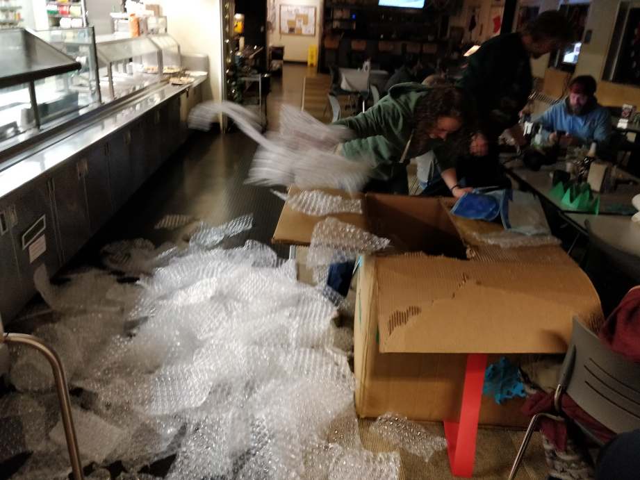 Person digging lots of bubble wrap out of large box