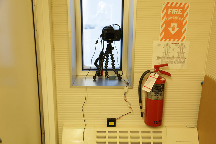 Camera on tripod in dorm window at South Pole station