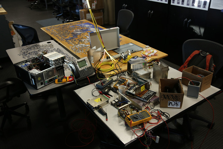 electronics taken apart on table next to jigsaw puzzle