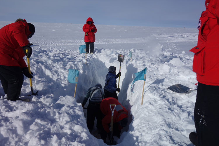 digging in the snow at the South Pole