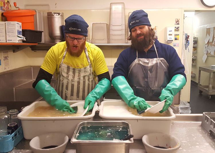 Winterovers cleaning dishes side by side