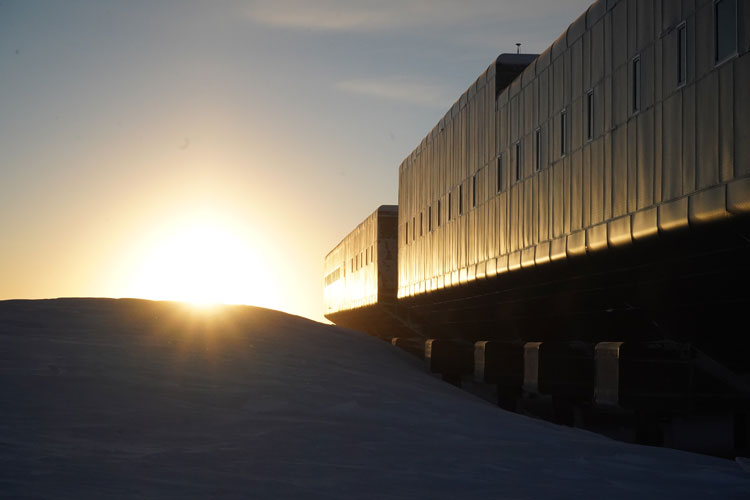 Sun peaking over snowdrift