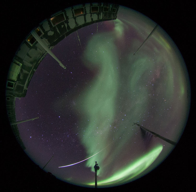 Auroras through the fisheye with a shooting star.