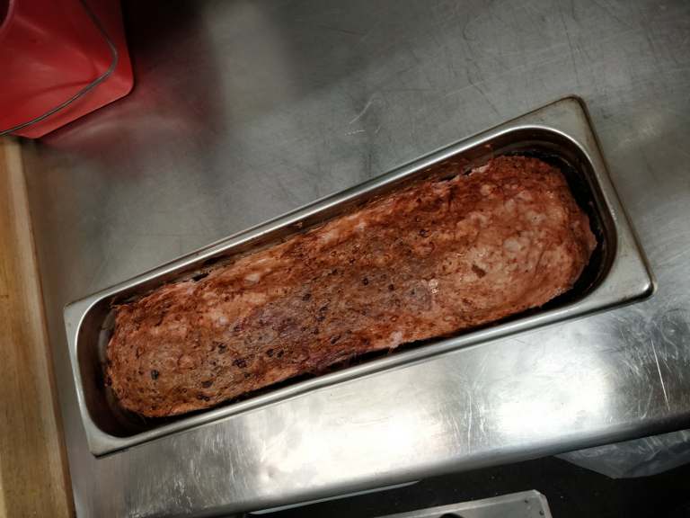 Close-up on meatloaf-like specialty in a long pan 