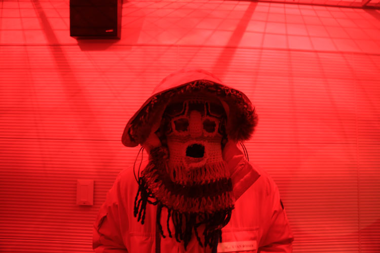 Mack in Ecuadorian devil's mask under red lights